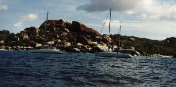 photo of boats near rocky coast
